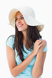Happy young brunette wearing sunhat