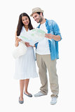 Happy hipster couple looking at map