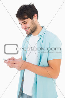 Happy casual man sending a text message