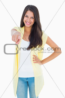 Happy casual woman pointing to camera