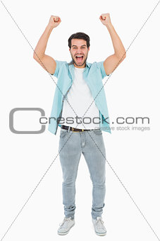 Happy casual man cheering at camera