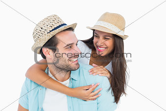Happy casual man giving pretty girlfriend piggy back