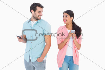 Happy couple sending text messages