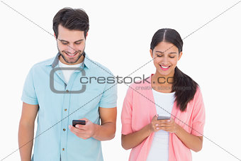 Happy couple sending text messages