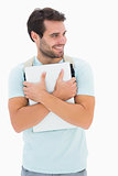 Handsome student carrying notepad and backpack