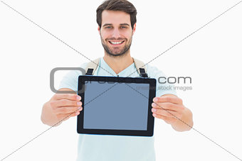 Handsome student showing his tablet pc