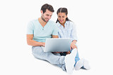 Cute couple sitting using the laptop