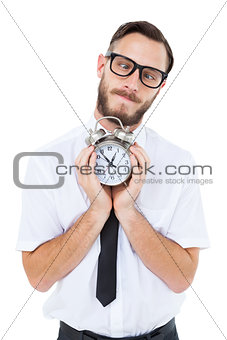 Geeky businessman holding alarm clock
