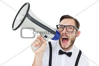 Geeky businessman shouting through megaphone