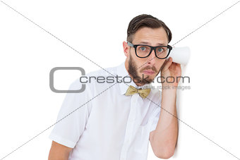 Geeky businessman eavesdropping with cup