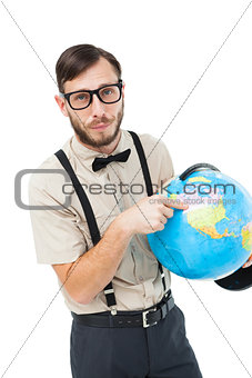 Geeky hipster pointing to globe
