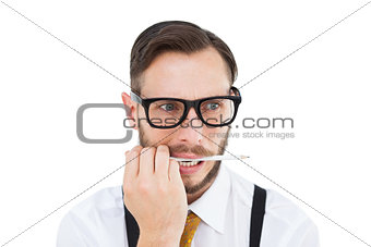 Geeky hipster biting on pencil
