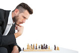 Hipster businessman playing game of chess