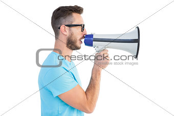 Handsome hipster talking through megaphone