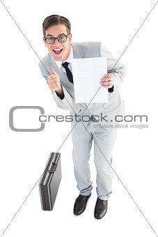 Geeky businessman showing page to camera