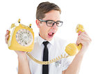 Geeky businessman shouting at retro phone