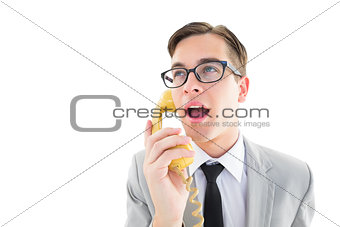 Geeky businessman talking on retro phone