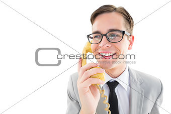 Geeky businessman talking on retro phone