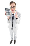 Geeky smiling businessman showing calculator