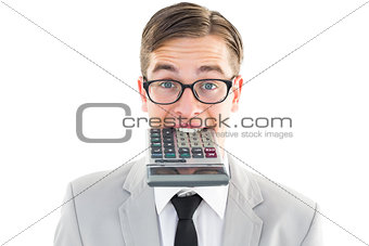 Geeky smiling businessman biting calculator