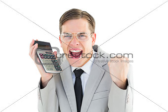 Geeky smiling businessman holding calculator
