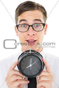 Geeky businessman holding alarm clock