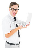 Geeky businessman holding his laptop