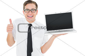 Geeky businessman holding his laptop showing thumbs up
