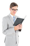 Geeky businessman reading black book