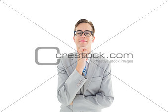 Geeky happy businessman thinking with hand on chin