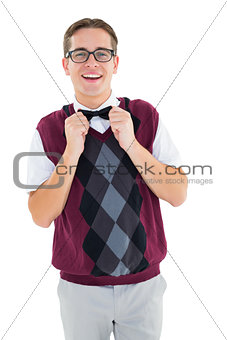 Geeky hipster fixing his bow tie