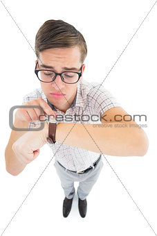 Geeky hipster pointing to his watch