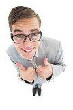 Geeky hipster smiling at camera with thumbs up