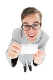 Geeky hipster smiling and showing card