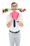 Geeky hipster holding red roses and heart card