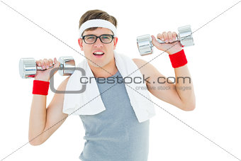 Geeky hipster lifting heavy dumbbells