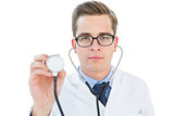 Handsome doctor listening with stethoscope