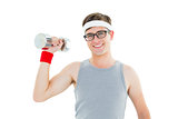 Geeky hipster posing in sportswear with dumbbell
