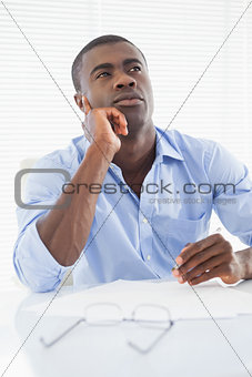 Thoughtful businessman sitting at his desk