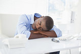 Tired businessman sleeping at his desk