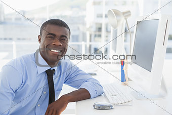 Smiling businessman working at his desk