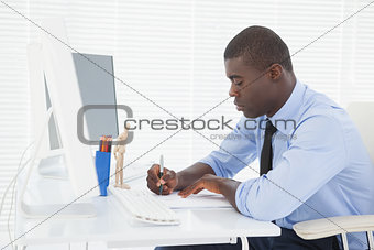 Handsome businessman working at his desk