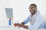 Hipster smiling businessman working at his desk