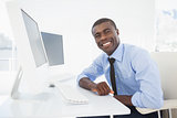 Happy businessman working at his desk