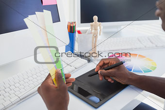 Designer sitting at his desk working with digitizer