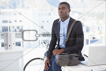 Thoughtful businessman with his bicycle