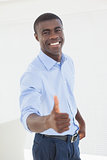 Happy businessman showing thumbs up