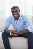 Happy businessman sitting on couch