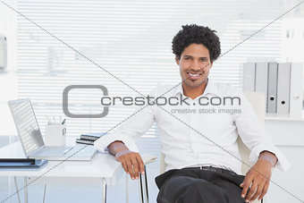 Handsome casual businessman smiling at camera