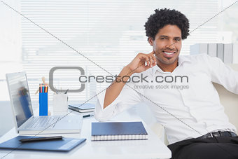 Happy businessman working at his desk